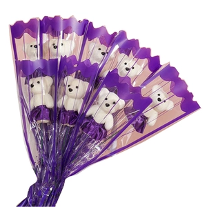 Gift bouquet featuring small white plush teddy bears in purple dresses for Valentine's Day