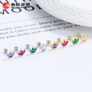 Detailed macro of 925 silver crown cartilage studs with colorful zircon stones and screw backs