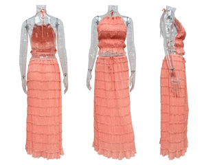 Three-angle view of pink halter crop top and pleated maxi skirt set on white background