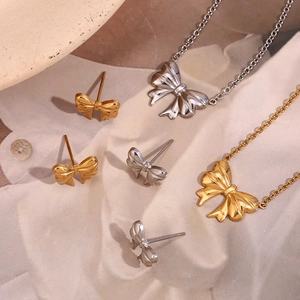 Golden and silver stainless steel ribbon bow pendant necklace and stud earrings set