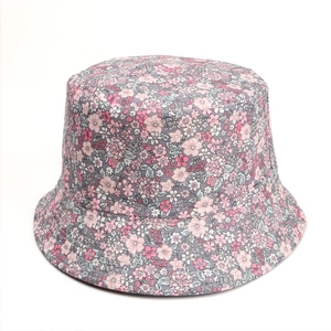 Close-up of floral pattern and stitching detail on a reversible cotton sun bucket hat