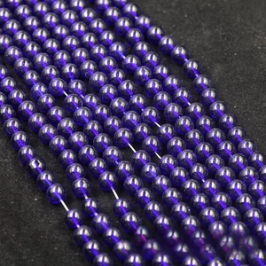 Macro shot of smooth dark blue translucent glass beads for DIY jewelry making