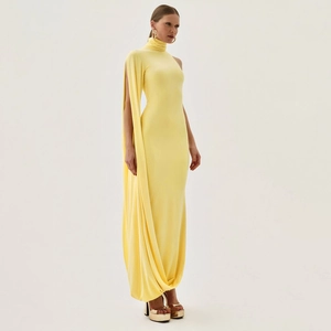 Detail of elegant yellow one-shoulder dress with high neck and flowing floor-length drape