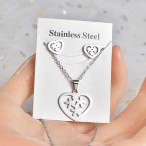 Stainless steel jewelry set featuring hollow heart pendants with clover patterns