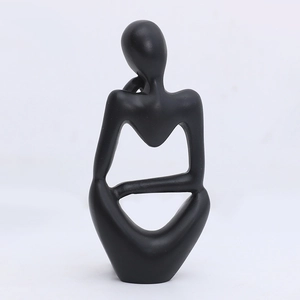 Minimalist Nordic abstract thinker sculpture in matte black resin for home office desk decor