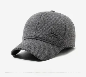 Detail view of the gray knit texture and metal side logo on the warm winter baseball cap