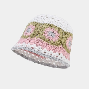 Detailed view of handmade crochet flower pattern and knit texture on bucket hat