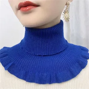 Detail of dark blue knitted fake collar with ribbed texture and ruffled hemline