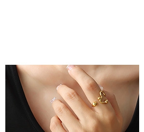 Close-up of golden irregular lava-style open ring featuring modern organic flow design