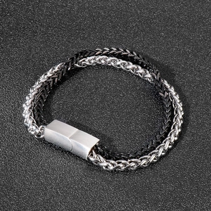 Detail of double-layer woven chain bracelet with brushed silver magnetic clasp closure