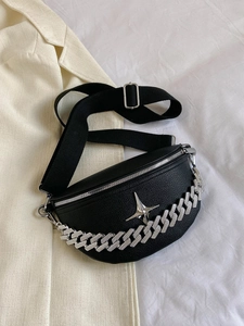 Close-up of black lychee leather waist bag with silver star logo and bold chunky chain