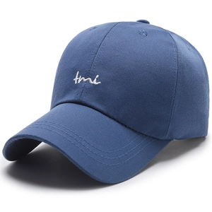 Blue cotton baseball cap with white TMI embroidery shown from a 45-degree angle