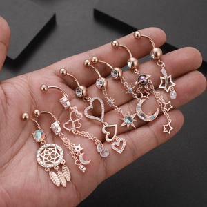 Set of 8 rose gold belly rings with heart, star, moon and dreamcatcher charms
