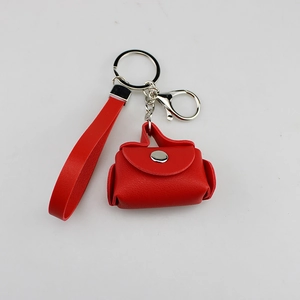 Detail of a red PU leather mini purse keychain with wrist strap