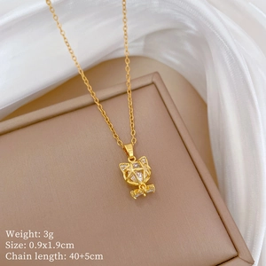 Detail of gold cat pendant with zircon crystal and small diamonds on silk