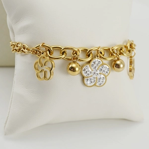 18K gold plated titanium steel rose bracelet with crystals on a jewelry pillow