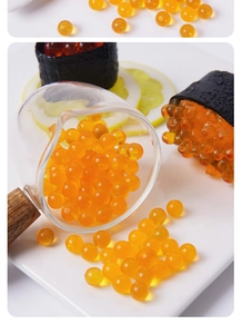 Macro view of realistic dollhouse miniature orange fish roe beads with wooden spoon