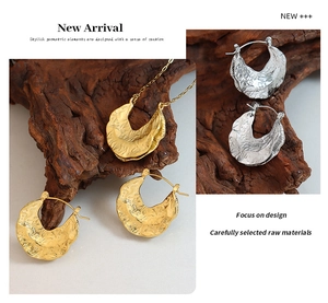Detailed view of irregular hammered crescent necklace and earrings set in gold and silver
