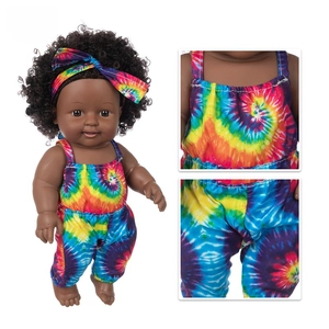 Detail of 12-inch black vinyl baby doll wearing colorful tie-dye outfit and headband