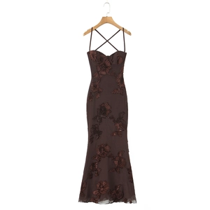Detail of cross back straps and 3D floral embroidery on a dark brown evening maxi dress