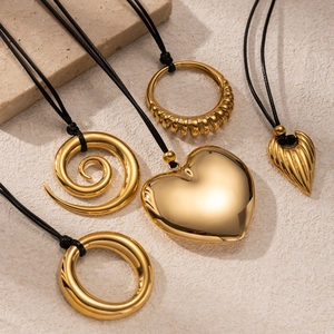 Modern gold stainless steel necklace pendants in heart and spiral shapes with black cords