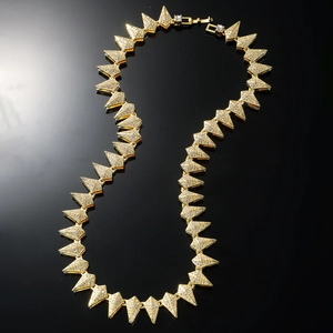 Hip hop gold plated pyramid link necklace with micro pave crystals on black background