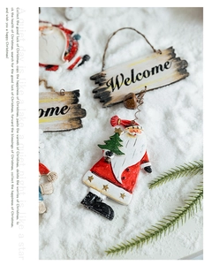 Close-up of vintage Santa Claus ornament with Welcome sign and metal bells for Christmas tree