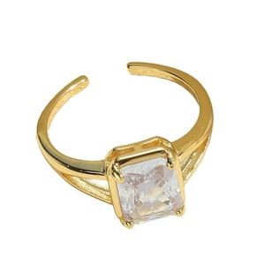 Adjustable gold ring with square crystal zircon and open band design on white background