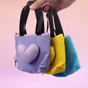 Mini shopping bag keychains in purple, yellow, and blue with heart charms and zippers