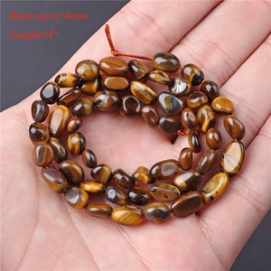 Macro shot of 6-8mm natural tiger eye beads for DIY jewelry making, 15 inch strand