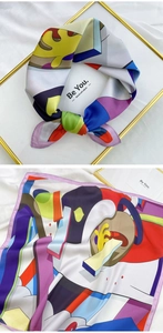 Detail view of colorful abstract geometric print silk scarf with modern artistic patterns