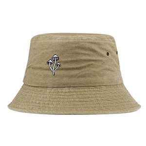 Detail of vintage khaki bucket hat with mushroom embroidery and metal ventilation eyelets