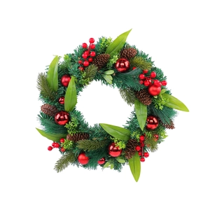 Christmas wreath with green pine needles, red berries, pine cones and shiny red ball ornaments
