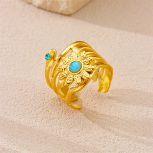 Detailed close-up of a 18k gold-plated sunflower ring with turquoise center stone