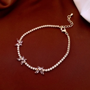 Detail of a gold butterfly tennis bracelet featuring lavender marquise zircons and lobster clasp