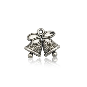 Macro detail of vintage silver double bell charms for DIY jewelry and Christmas pendants