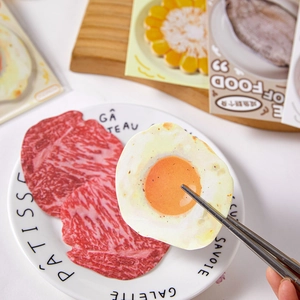 Creative food-shaped sticky notes featuring fried egg and raw beef designs on a plate