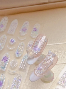 Close-up of 3D embossed shell luster nail art stickers with purple floral window design