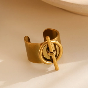 Macro shot of wide gold-plated stainless steel ring with industrial T-clasp detail