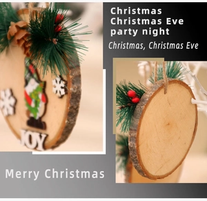 Close-up of wooden Christmas gnome ornament with pine needles and JOY lettering