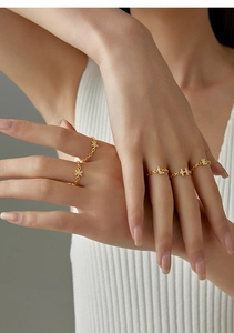 Detailed macro shot of gold-plated chain ring with sparkling letter H encrusted with zircons