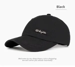 Close-up of black cotton baseball cap with metallic letter logo and fashion embroidery