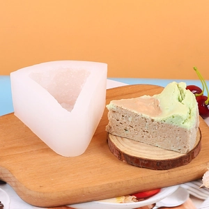Macro shot of triangular silicone waffle mold with finished croissant cake on wooden board