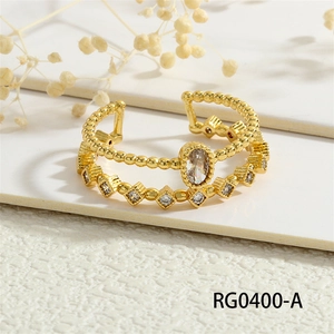 Close-up of double layer gold ring with cubic zirconia on a minimalist white surface