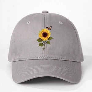 Close-up of sunflower and butterfly print on the front of a gray cotton baseball cap