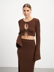 Detail of cocoa brown ribbed knit set featuring a tie-front top and side-slit maxi skirt