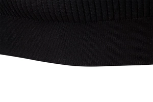 Close-up of premium black ribbed knit texture on the sleeve cuff of a men's shirt