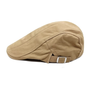 Detail view of khaki newsboy cap showing twill fabric and adjustable silver buckle