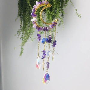 Detail of amethyst moon suncatcher with golden crescent frame and crystal prisms