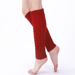 Detailed knit texture of red cable-knit leg warmers in a stylish over-the-knee length
